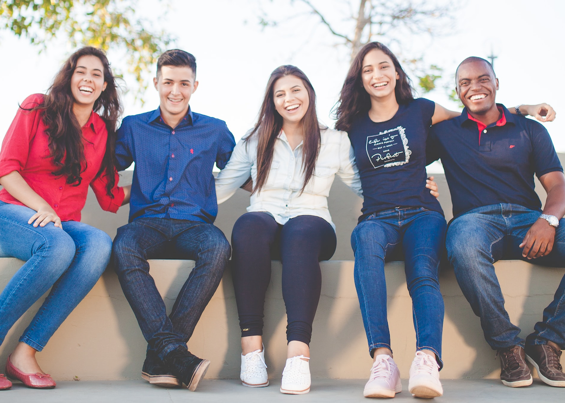 Group of teen friends sitting and smiling