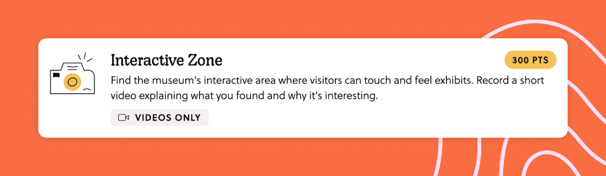 A mission titled "Interactive Zone". The task is to take a photo: "Find the museum's interactive area where visitors can touch and feel exhibits. Record a short video explaining what you found and why it's interesting."